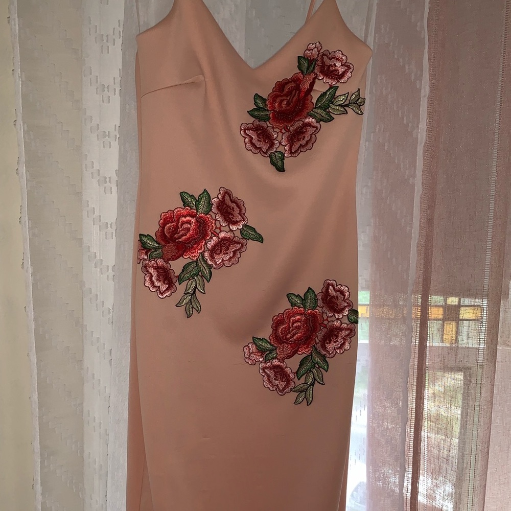 Peach spaghetti strap midi dress, floral accents.